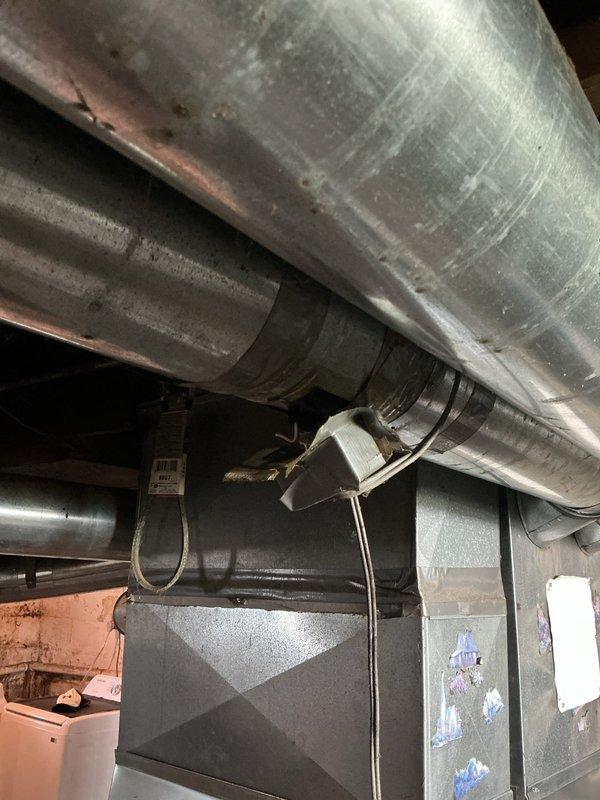 Responded to service call for 9-year-old furnace with reported slamming damper noise in ductwork system. Upon inspection of the HVAC infrastructure, examined the flexible metallic ductwork, main supply ducts, and air handler connections throughout the basement area. Investigated potential sources of noise including loose duct strapping, unsecured flexible duct sections, and vibration points where ductwork interfaces with the furnace unit. Documented existing conditions of the galvanized metal ductwork and air distribution system for customer records.