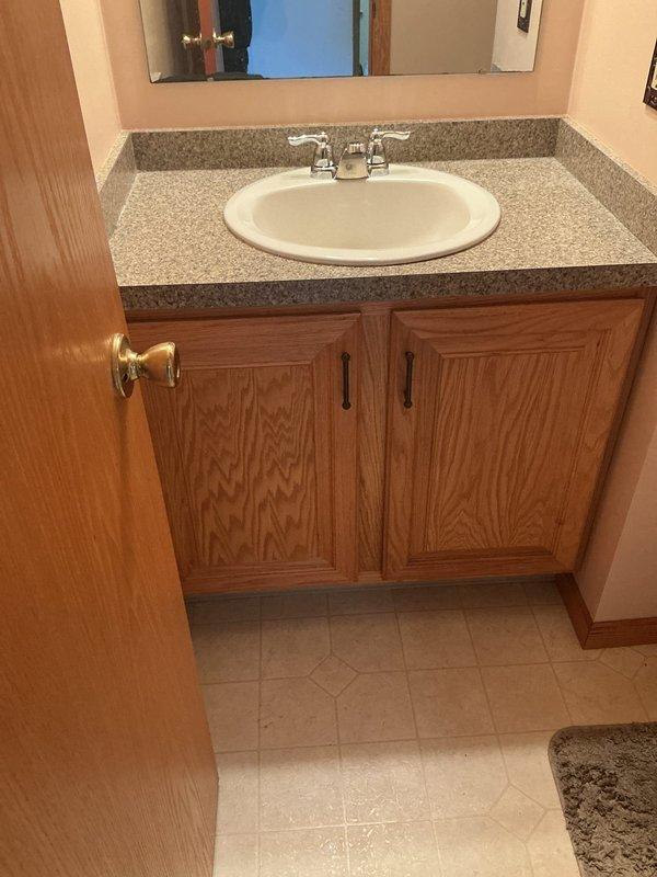 Successfully completed a comprehensive plumbing upgrade involving multiple fixture replacements throughout the residence. Replaced the shower valve in the upstairs hallway bathroom with a new single-handle chrome control valve, ensuring proper water flow and temperature regulation. Installed a new tub spout with diverter mechanism to complement the valve replacement.

Installed a new water softener system, including all necessary tubing and connections to integrate with the existing plumbing infrastructure. Staged and positioned the softener unit for optimal performance and accessibility for future maintenance.

Replaced the kitchen faucet with a new fixture, ensuring proper seal and connection to supply lines. Additionally, replaced the bathroom vanity faucet with a chrome two-handle unit, verifying proper installation on the speckled gray laminate countertop with white oval drop-in sink.

All fixtures were tested for proper operation, water pressure, and leak-free connections. The in