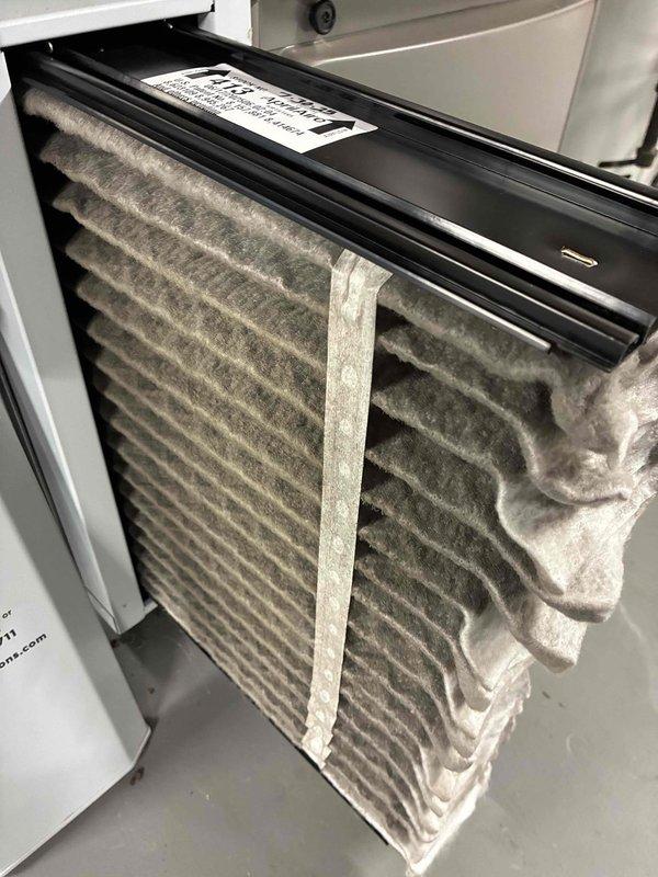 Completed first MVP maintenance visit on Lennox heating and cooling system following initial installation. Inspected furnace, air handler, and associated components including PVC venting, ductwork connections, and Aprilaire humidifier unit. Documented heavily soiled air filter requiring replacement due to significant dust and debris accumulation across pleated surface. Verified system operation, checked all connections, and photographed equipment condition for service records.