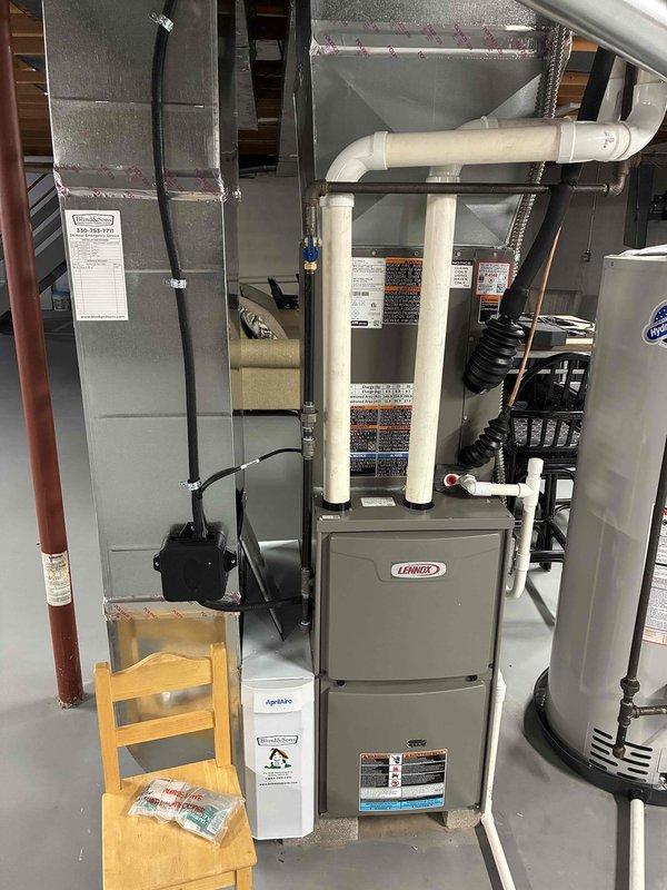 Completed first MVP maintenance visit on Lennox heating and cooling system following initial installation. Inspected furnace, air handler, and associated components including PVC venting, ductwork connections, and Aprilaire humidifier unit. Documented heavily soiled air filter requiring replacement due to significant dust and debris accumulation across pleated surface. Verified system operation, checked all connections, and photographed equipment condition for service records.