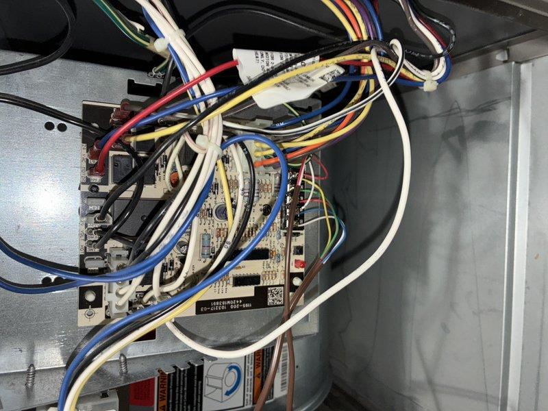 Completed routine BS-MVP cooling maintenance visit on an 8-year-old air conditioning system. Performed comprehensive inspection of outdoor condensing unit, including examination of control board circuitry, wiring connections, and electrical components. Verified proper operation of capacitor, contactor relay, and all wire terminations. Documented system condition through photographic records showing control board assembly with color-coded wiring (blue, white, yellow, red, and black conductors) properly secured with wire ties, and cylindrical capacitor with multiple electrical connections intact. All components found in satisfactory working condition with no immediate repairs required.