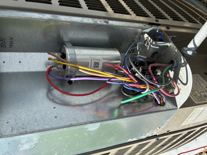 Completed routine BS-MVP cooling maintenance visit on an 8-year-old air conditioning system. Performed comprehensive inspection of outdoor condensing unit, including examination of control board circuitry, wiring connections, and electrical components. Verified proper operation of capacitor, contactor relay, and all wire terminations. Documented system condition through photographic records showing control board assembly with color-coded wiring (blue, white, yellow, red, and black conductors) properly secured with wire ties, and cylindrical capacitor with multiple electrical connections intact. All components found in satisfactory working condition with no immediate repairs required.