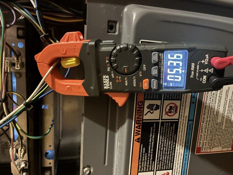 Completed MVP Cooling Visit performing comprehensive diagnostic testing and visual inspection of residential HVAC system. Utilized digital multimeter with clamp meter to measure electrical current draw on system components, confirming proper amperage readings at 0.58 amps on tested circuit. Removed access panel and inspected furnace internal components including blower motor assembly, electrical connections, wire terminations with wire nuts, control circuitry, and refrigerant lines. All components found operating within normal parameters with no deficiencies noted.