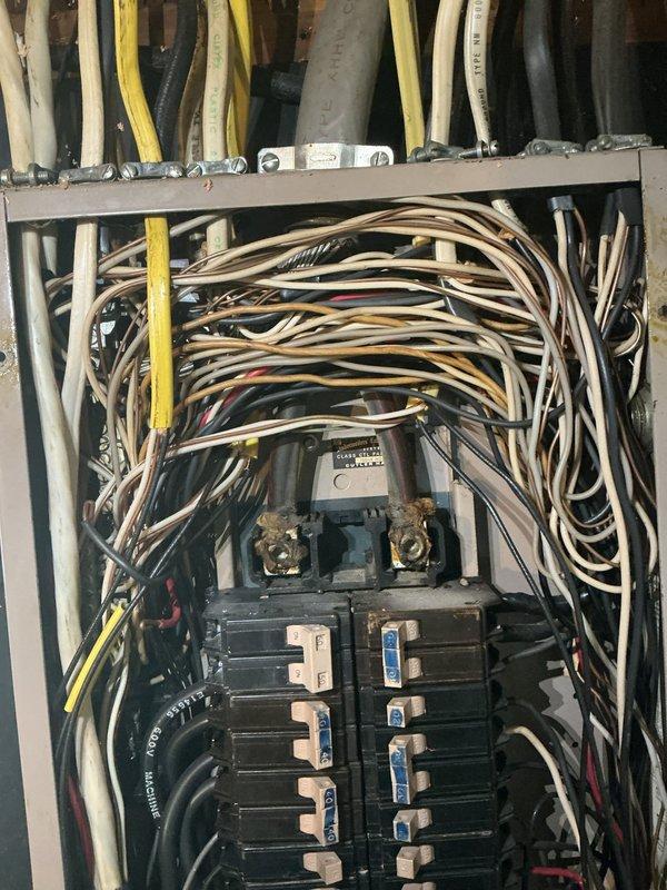 Responded to water intrusion issue affecting electrical panel in 79-year-old residential structure. Upon inspection, documented exterior wall conditions and identified potential moisture entry points near panel location. Evaluated interior panel box containing multiple circuit breakers and extensive wiring network, photographed existing electrical distribution system configuration, and assessed potential water damage risks to electrical components and connections.