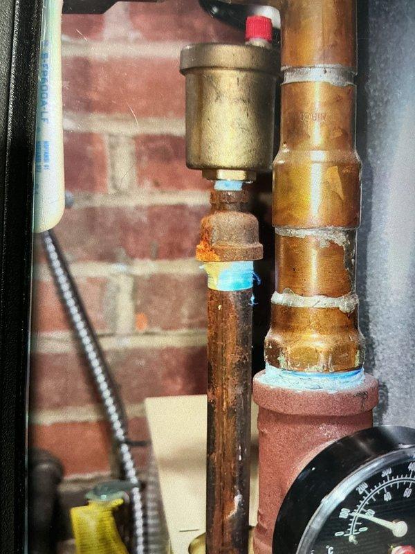 Completed scheduled tune-up maintenance on 7-year-old boiler system located in basement. Performed comprehensive inspection of all components including circulator pump (Taco 007-F5 model), pressure relief systems, automatic air vent, and associated piping. Noted moderate corrosion present on copper piping connections and threaded fittings, particularly around vertical supply lines, consistent with age of system. Verified proper operation of circulator pump, tested pressure gauge readings, and confirmed all isolation valves functioning correctly. System operating within normal parameters with no immediate repairs required at this time.