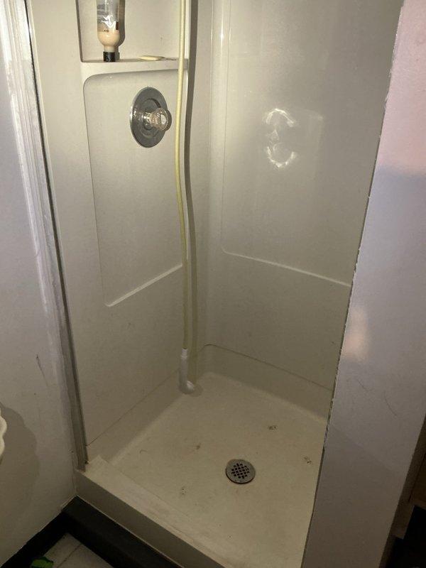 Responded to a clogged floor drain at a residential property constructed in 1970. Successfully snaked out the drain line to restore proper flow and drainage. The floor drain, located in the basement shower area near water filtration equipment, was cleared of blockage using mechanical cable equipment, and system was tested to confirm full functionality upon completion.