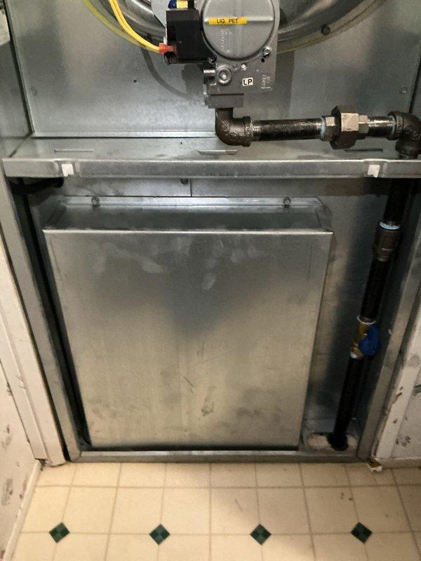Responded to urgent callback for water discharge near HVAC equipment following previous service attempt. Upon inspection, documented interior components of heating system including gas valve assembly, blower motor, and cabinet configuration. Investigated source of water accumulation that intensified during AC operation to identify failed drainage or condensate issue requiring immediate attention.