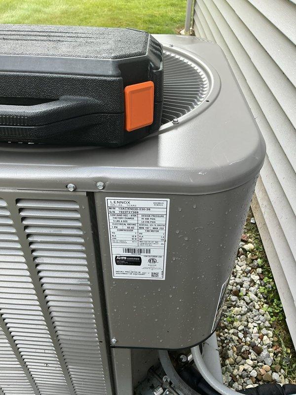 Completed MVP recurring cooling maintenance visit on Lennox air conditioning system. Upon arrival, noted significant dirt accumulation, grime buildup, and discoloration on condenser unit exterior panels and heat exchange fins, with visible streaking patterns and possible mold growth indicating extended exposure to environmental elements. Performed standard preventive maintenance procedures including system inspection and documentation with photographs of unit condition and manufacturer specifications label for service records.