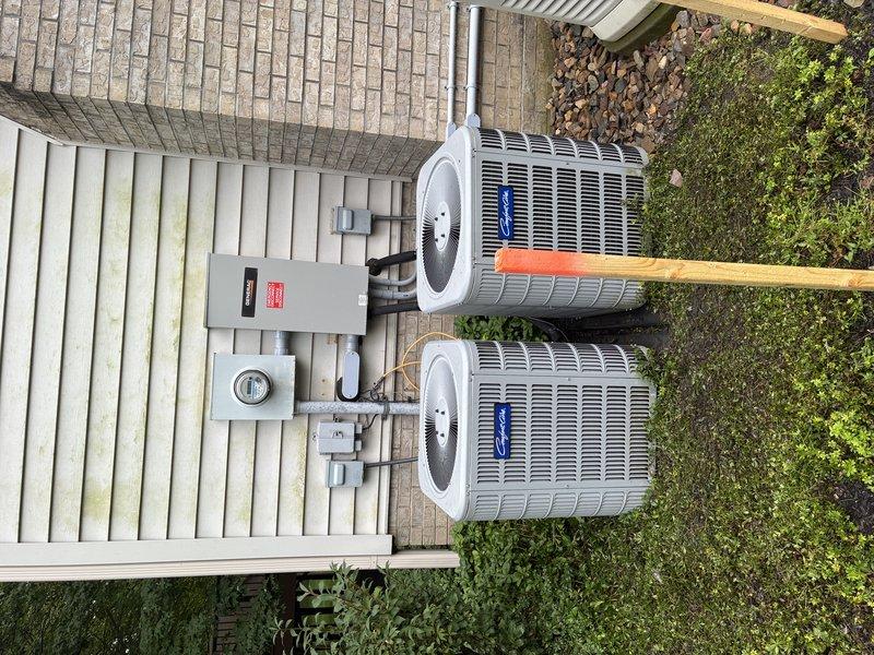 Completed scheduled MVP cooling maintenance visit on dual outdoor condensing units positioned on concrete pad. Performed comprehensive system inspection including electrical connections, contactors, and control wiring. Removed access panels to inspect internal components and verified proper wiring configuration with multiple circuit connections. Checked condenser coil condition and confirmed adequate airflow through heat exchanger fins. Inspected electrical disconnect panel and metering equipment mounted on building exterior. Verified both units operational with no deficiencies noted. System operating within normal parameters upon completion of maintenance protocol.