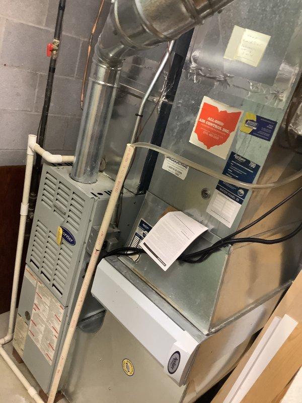 Provided comprehensive estimate for replacement of 19-year-old furnace and air conditioning system. Documented existing Carrier HVAC equipment and associated ductwork, copper refrigerant lines, and installation configuration in basement utility area for MVP replacement proposal.