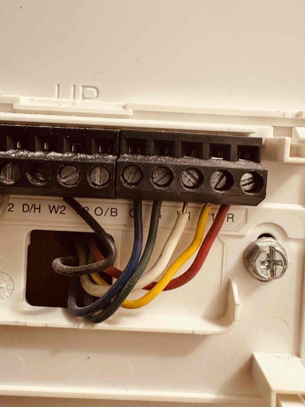 Replaced malfunctioning M30 thermostat with new unit. Completed proper wiring connections to terminal block including all HVAC control wires (heating, cooling, and reversing valve circuits) and verified secure terminations at both the thermostat and control board. System tested and operational upon completion.