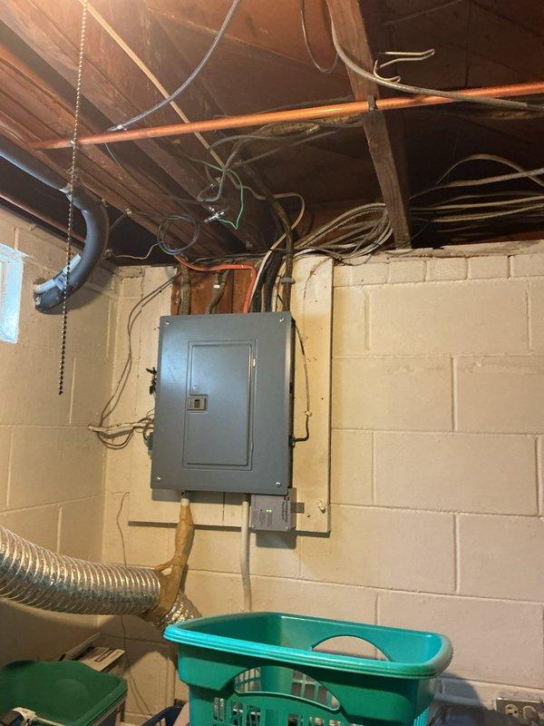 Relocated exterior hose bibb water supply line to maintain proper clearance from electrical service panel in basement utility area. Rerouted copper piping using truck stock materials to ensure compliance with safety codes requiring separation between plumbing and electrical systems. Work completed in approximately one hour with no additional parts required.