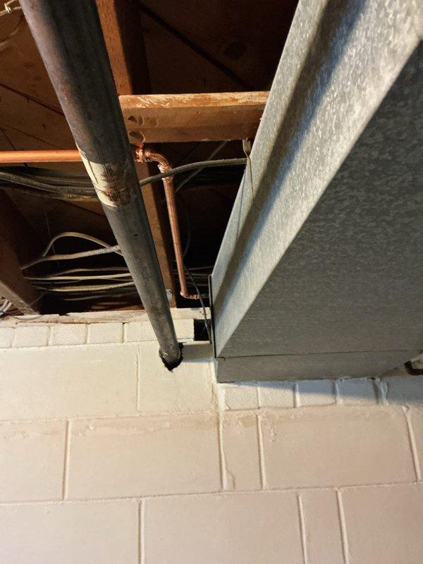 Relocated exterior hose bibb water supply line to maintain proper clearance from electrical service panel in basement utility area. Rerouted copper piping using truck stock materials to ensure compliance with safety codes requiring separation between plumbing and electrical systems. Work completed in approximately one hour with no additional parts required.