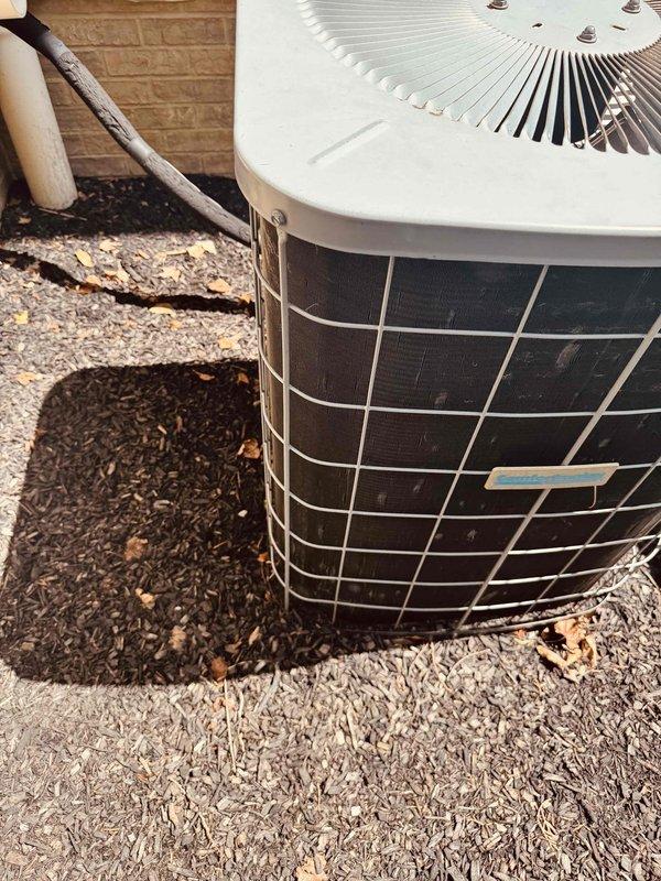 Responded to no cooling call on 20-year-old residential air conditioning system serving main level. Upon arrival, performed diagnostic evaluation of outdoor condensing unit and associated components. Unit showed signs of age-related wear consistent with equipment at end of expected service life. Documented current condition of system with photos showing outdoor unit placement, refrigerant line routing, and protective grille installation. Customer advised of findings and provided recommendations for system replacement due to age and efficiency considerations.
