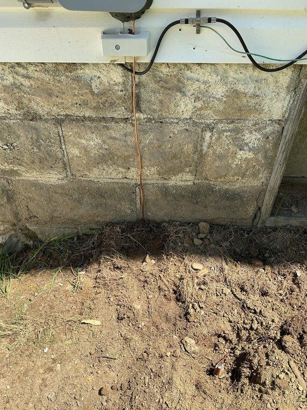 Replaced 100 amp exterior electrical service panel and installed new wiring routed through protective conduit along the exterior concrete block foundation wall. Mounted new junction box with proper grounding connections and secured all conduit runs to meet code requirements for exterior installations.