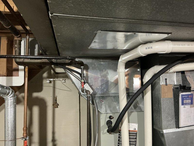 Conducted comprehensive assessment of residential HVAC system experiencing major refrigerant leak resulting in complete loss of cooling capacity. Identified significant crack in furnace heat exchanger posing safety concern. Provided detailed replacement estimate for air conditioning system and recommended obtaining quote for complete system replacement versus partial repair approach. Documented existing Trane furnace installation, ductwork configuration, refrigerant lines, and condensate drainage system. Scheduled follow-up appointment with equipment buyback option to finalize replacement decision.
