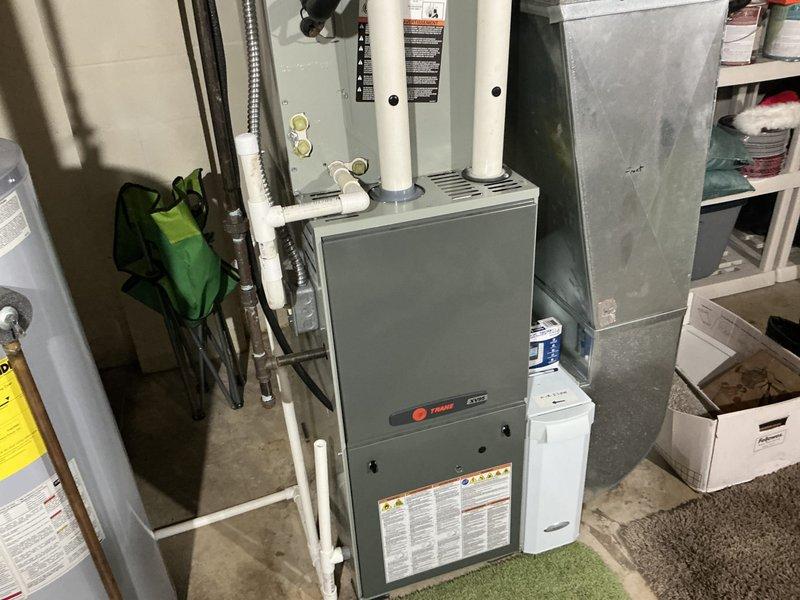 Conducted comprehensive assessment of residential HVAC system experiencing major refrigerant leak resulting in complete loss of cooling capacity. Identified significant crack in furnace heat exchanger posing safety concern. Provided detailed replacement estimate for air conditioning system and recommended obtaining quote for complete system replacement versus partial repair approach. Documented existing Trane furnace installation, ductwork configuration, refrigerant lines, and condensate drainage system. Scheduled follow-up appointment with equipment buyback option to finalize replacement decision.