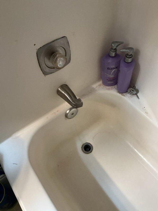 Replaced chrome tub spout and faucet handle assembly in main bathroom bathtub. Addressed frozen/seized shower handle in master bathroom by disassembling valve trim, applying penetrating lubricant to cartridge mechanism, and restoring full operational function to temperature control handle.