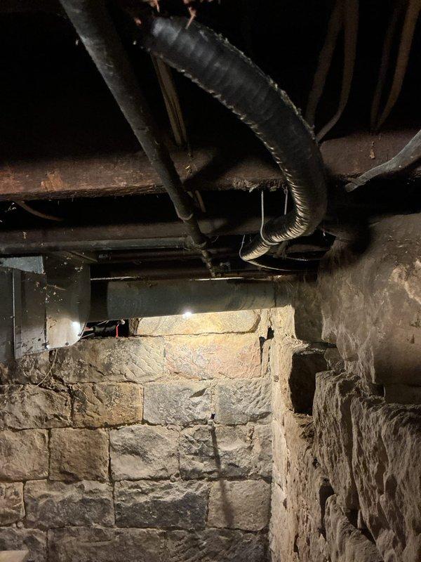 Installed 25 feet of above-ground gas piping using pre-staged materials including gas line kit and pipe components. Routed new gas line through crawlspace area beneath floor joists alongside existing mechanical systems and stone foundation wall. Installation completed and confirmed operational per specifications.