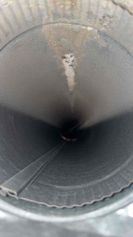 Completed comprehensive duct cleaning service for residential HVAC system with potential scope of up to 30 vents, with initial service covering the first 14 registers. Pre-service inspection revealed visible contamination within the ductwork, including white residue deposits, discoloration, and signs of aging on interior metal surfaces. Performed thorough cleaning of flexible and rigid sheet metal ductwork sections, addressing accumulated debris and surface contamination throughout the system. Documentation photos captured pre-cleaning conditions showing interior duct surfaces with weathering, residue buildup, and corrosion indicators, as well as blower motor assembly connections with proper gasket sealing intact.