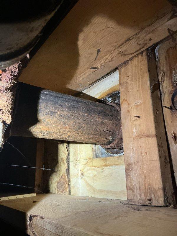 Responded to water leak from upstairs bathroom toilet into basement crawl space. Inspected crawl space framing and identified active water infiltration affecting structural lumber and insulation. Examined toilet installation in upstairs bathroom, checked wax ring seal, flange connection, and supply line integrity. Repaired faulty wax ring seal at toilet base to eliminate leak source and prevent further water damage to basement area.