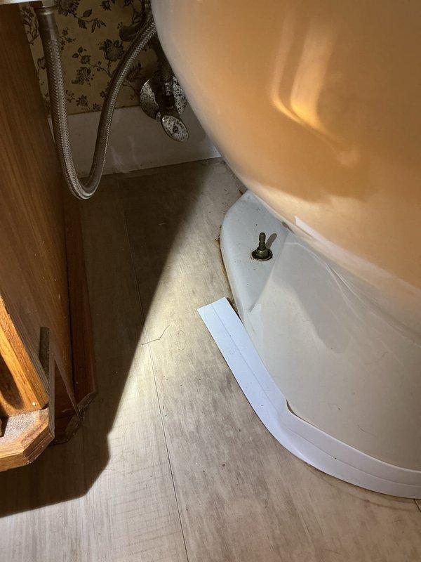 Responded to water leak from upstairs bathroom toilet into basement crawl space. Inspected crawl space framing and identified active water infiltration affecting structural lumber and insulation. Examined toilet installation in upstairs bathroom, checked wax ring seal, flange connection, and supply line integrity. Repaired faulty wax ring seal at toilet base to eliminate leak source and prevent further water damage to basement area.