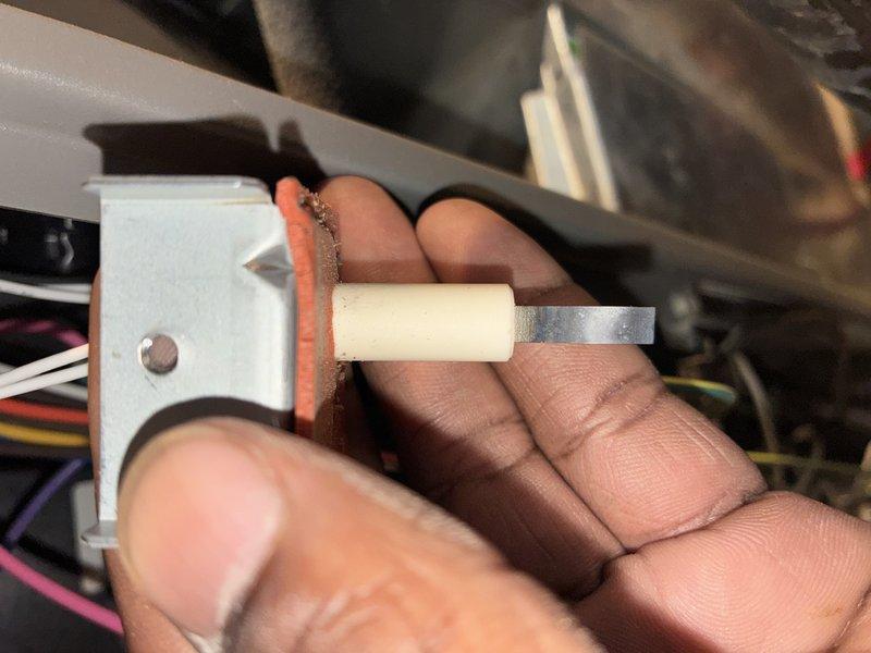 Completed furnace maintenance visit on a 9-12 year old heating system. Inspected and replaced flame sensor due to heavy oxidation and corrosion buildup on the sensor rod and electrical connector contacts. The degraded sensor condition was causing improper flame detection and operational issues. Removed failed component, installed new flame sensor, verified proper electrical connections, and tested system operation to ensure reliable heating performance.