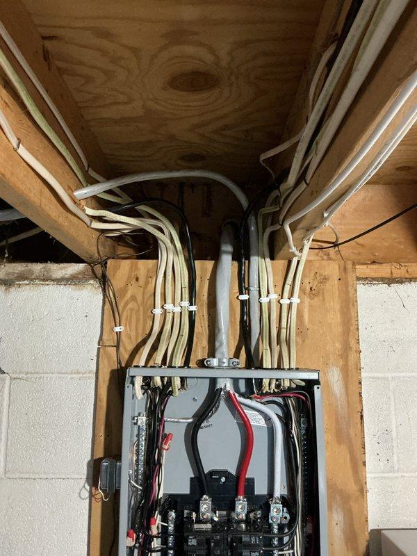 Completed 150-amp electrical service upgrade with installation of new main breaker panel and circuit breakers to meet 2023 National Electrical Code requirements. Installed exterior disconnect switch as mandated by current code standards. Added whole home surge protection device to safeguard electrical system and connected appliances. Performed all necessary wiring updates and code-compliant modifications throughout the installation. Additionally, replaced failed ballast in lighting fixture near water meter location and installed LED bypass bulbs for improved efficiency and reliability. All work completed with proper wire management, secure cable routing, and professional panel organization.