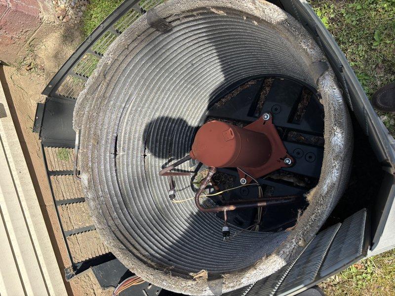 Completed annual maintenance on 11-year-old air conditioning system. Inspected outdoor condenser unit and found significant debris accumulation including leaves, dirt, and organic matter throughout the unit and on internal components. Cleaned condenser coil, removed debris from base pan and surrounding areas, and inspected all electrical connections. Evaluated ductwork condition for potential cleaning needs and noted visible rust on refrigerant lines and corrosion on metal components due to outdoor exposure. System operational following service.