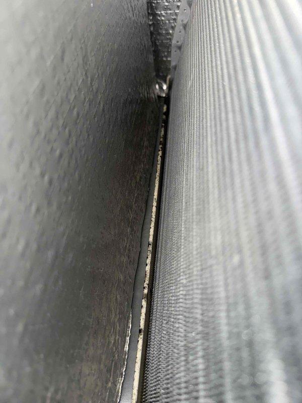 Completed scheduled MVP cooling maintenance visit on 4-year-old HVAC system. Upon inspection, identified debris accumulation along ductwork seam joints and dust buildup on blower housing components. Observed moisture and particulate matter inside blower assembly access port, indicating potential condensate drainage concerns. Documented system condition through photographic evidence showing ductwork junction points and blower compartment interior for maintenance records.