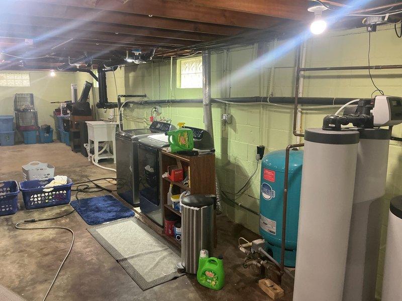 Responded to service call for ongoing water odor issue affecting entire household with 70-year-old home. Inspected tanked water heater system and associated plumbing components in basement utility area. Upon arrival, observed water heater installation alongside pressure tank and water treatment equipment. Conducted thorough diagnostic assessment of water heater unit, checking anode rod condition, sediment accumulation, and temperature settings as potential sources of sulfur or bacterial odor. Examined copper supply lines, inlet/outlet connections, and pressure relief valve for any signs of contamination or system issues. Evaluated pressure tank and filtration system integration with water heater to determine if odor originated from heating unit or upstream water treatment components. Photographed equipment configuration showing water heater with circulation pump assembly, Fil-Rite pressure tank, and associated piping for warranty documentation purposes. Advised customer on findings and