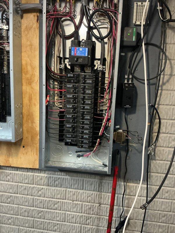 Completed a 150-amp electrical service upgrade with all necessary code updates to meet 2023 National Electrical Code requirements, including installation of an exterior disconnect. Installed whole home surge protection system with digital monitoring capability. Ran a new dedicated 20-amp circuit to the garage for refrigerator operation. Replaced six 3-way switches, two dimmer switches, and one fan control switch throughout the residence. Installed two new light fixtures—one in the sunroom and one in the first-floor hallway. Corrected the dishwasher circuit by reworking the connection and properly placing it on the correct leg of the multi-wire branch circuit to ensure balanced loading and safe operation. All electrical panels were mounted on wooden backing boards with proper wire management, featuring organized color-coded wiring and professional conduit installation. The upgraded system now includes multiple distribution panels with circuit breakers arranged for optimal circuit protec