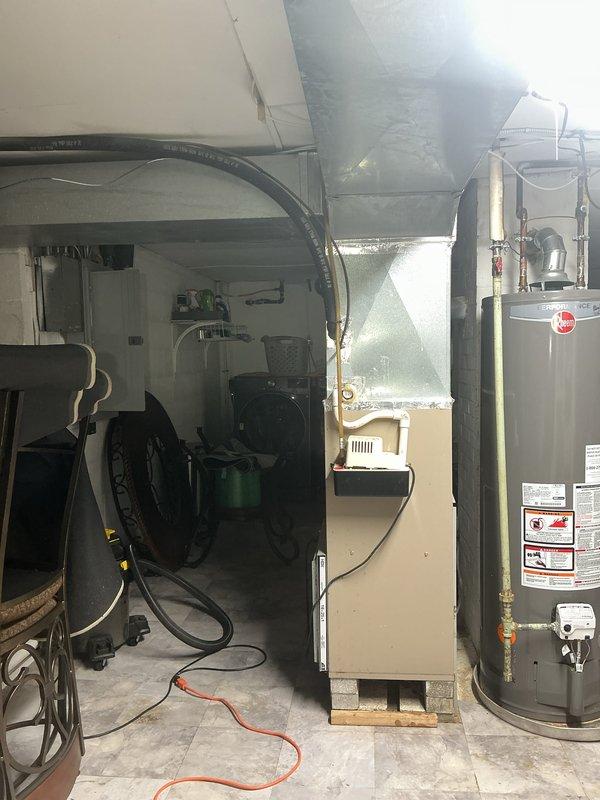 Completed installation of a 90% efficiency furnace system with new first-floor ductwork modifications. Installed one new supply duct and two new return air ducts on the first floor to improve airflow distribution and system performance. The new furnace unit was positioned in the basement utility area with proper venting and metallic ductwork connections extending to the ceiling distribution system. All ductwork was properly sealed and insulated with reflective material to maximize efficiency. System was tested and verified operational upon completion.