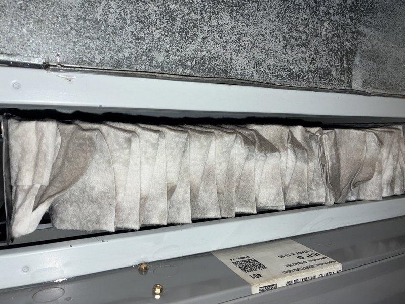 Completed preventive maintenance on a 5-year-old outdoor air conditioning unit. Inspected and documented the condition of the air handler's filtration system, noting dust accumulation on pleated filters, and examined the blower wheel assembly, which showed normal operational debris buildup on the squirrel cage fan blades. System components were assessed for proper operation and maintenance needs.