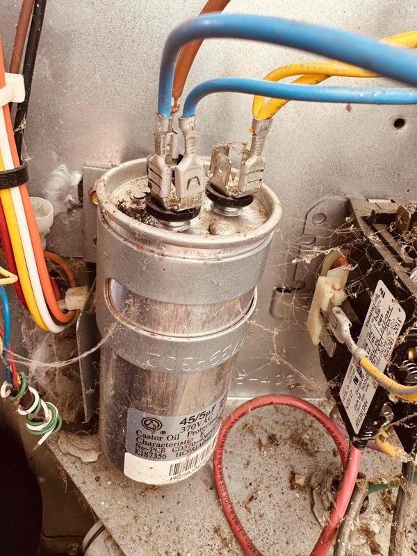 Responded to no cooling call on 10-year-old air conditioning system. Upon inspection, found failed dual-run capacitor with visible signs of age and deterioration. Replaced defective 45/5 MFD capacitor with new Totaline unit rated at 370/440 VAC. Verified all electrical connections, tested system operation, and confirmed unit returned to normal cooling function. Provided maintenance plan information via email for customer review.