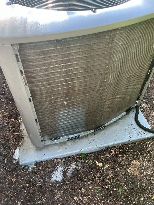 Completed comprehensive preventive maintenance on a 5-year-old residential air conditioning system as part of routine seasonal tune-up. Upon arrival, contacted customer via phone and announced presence at property as requested. Performed complete system inspection including visual assessment of outdoor condensing unit, which revealed significant accumulation of dirt, dust, and debris on condenser coils and fin surfaces. Cleaned condenser coils to restore proper airflow and heat transfer efficiency. Inspected fan motor assembly, fan blades, and protective grille for proper operation. Verified electrical connections and conduit routing. Checked refrigerant lines for proper insulation and secure mounting. Assessed concrete equipment pad condition and noted minor efflorescence but pad remains structurally sound. Cleared surrounding area of vegetation debris to ensure adequate clearance for airflow. Tested system operation including compressor startup, fan motor performance, and overall coo