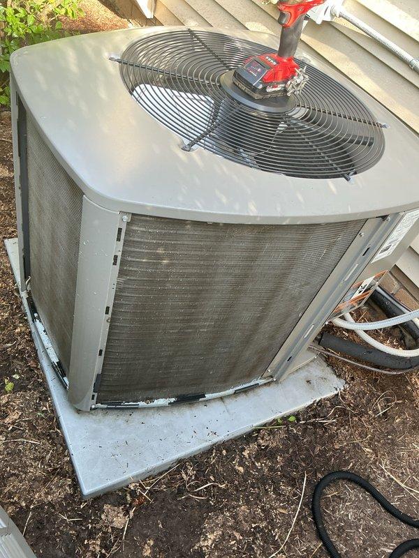Completed comprehensive preventive maintenance on a 5-year-old residential air conditioning system as part of routine seasonal tune-up. Upon arrival, contacted customer via phone and announced presence at property as requested. Performed complete system inspection including visual assessment of outdoor condensing unit, which revealed significant accumulation of dirt, dust, and debris on condenser coils and fin surfaces. Cleaned condenser coils to restore proper airflow and heat transfer efficiency. Inspected fan motor assembly, fan blades, and protective grille for proper operation. Verified electrical connections and conduit routing. Checked refrigerant lines for proper insulation and secure mounting. Assessed concrete equipment pad condition and noted minor efflorescence but pad remains structurally sound. Cleared surrounding area of vegetation debris to ensure adequate clearance for airflow. Tested system operation including compressor startup, fan motor performance, and overall coo