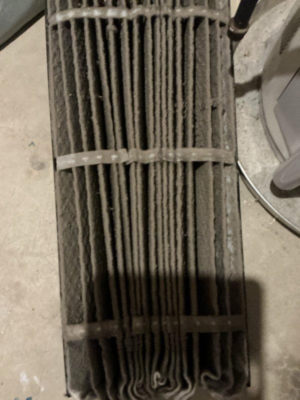 Completed preventive maintenance tune-up on 4-year-old residential air conditioning system and Lennox furnace with Aprilaire humidifier. Discovered heavily soiled evaporator coil with significant dust and debris accumulation restricting airflow and reducing heat transfer efficiency. Documented equipment condition with photographs showing clogged coil fins and contamination throughout component. Customer supplied furnace filter for replacement; provided quote for humidifier air filter replacement as requested.