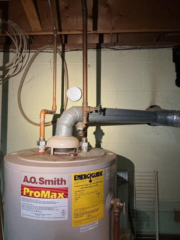 Conducted on-site assessment of existing conventional tank-style water heater for potential replacement with tankless system. Inspected current A.O. Smith ProMax storage tank water heater installation, documenting existing copper supply line configurations, venting arrangements, and utility room layout. Photographed current equipment condition, plumbing connections, and available space for equipment upgrade evaluation. Provided customer with comprehensive quote for tankless water heater installation including necessary modifications to gas line sizing, electrical requirements, and venting system reconfiguration.
