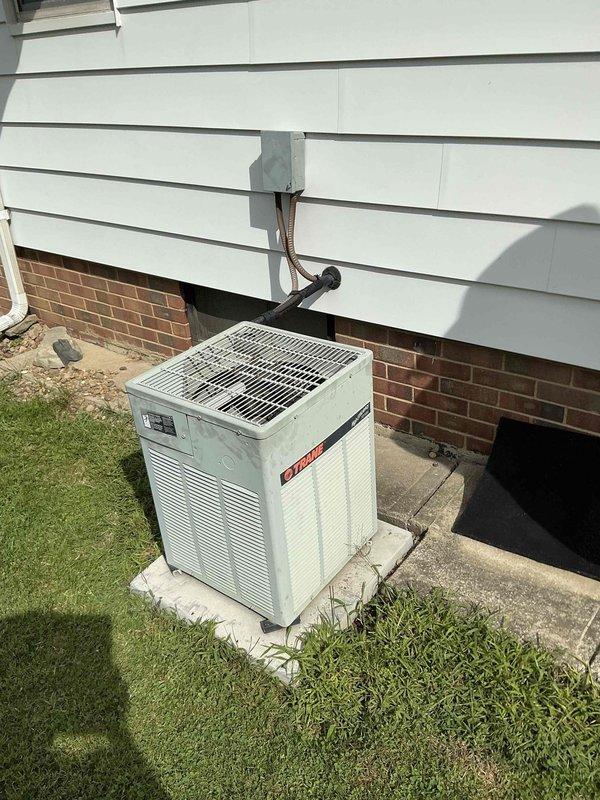 Conducted comprehensive HVAC system evaluation for equipment replacement estimate. Assessed existing gas furnace/air handler unit located in basement utility area, including connected ductwork distribution system, copper refrigerant lines, and electrical connections. Evaluated outdoor condensing unit positioned on concrete pad adjacent to building foundation, inspecting refrigerant line sets, electrical conduit routing, and overall system configuration. Documented current equipment specifications, installation conditions, and provided replacement recommendations based on system age and performance requirements.