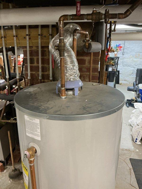 Provided estimate for replacement of existing 48-gallon natural gas water heater in 120-year-old residential property. Inspected current Bradford White model RG250L6N with 40,000 BTU/hr input rating, short tank configuration, located in basement utility area with exposed brick construction and copper supply piping. Documented existing installation including top-mounted connections, natural draft venting system, and current plumbing configuration for replacement specifications. Customer requested expedited installation scheduling for following day.