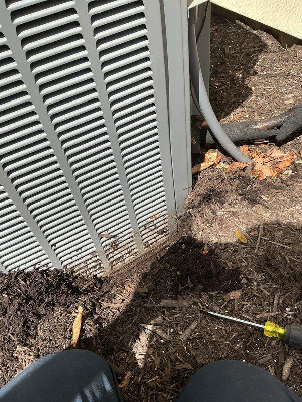 Completed maintenance tune-up on two 15-year-old outdoor AC units. Cleared significant accumulation of mulch, leaves, and organic debris from around and beneath both units to restore proper airflow and prevent potential drainage issues. Inspected refrigerant lines, verified proper connections, and ensured both systems were operating within normal parameters.