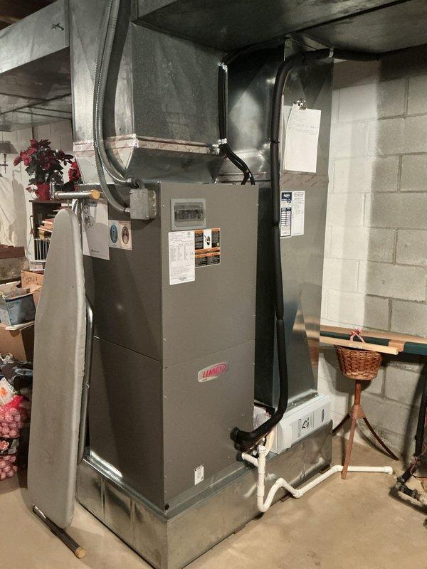Completed comprehensive tune-up service on 5-year-old Lennox heat pump and furnace system. Performed full system inspection including outdoor heat pump unit positioned on concrete pad with proper elevation, verified all electrical connections and conduit routing along exterior wall, and inspected indoor furnace unit in basement with associated ductwork and PVC condensate drainage system. All components operating within manufacturer specifications, no deficiencies noted, and system ready for continued reliable operation.