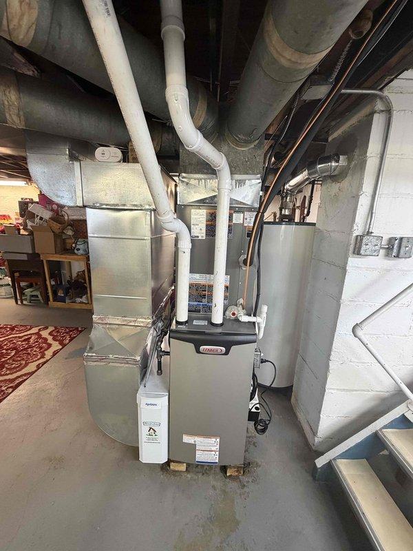 Completed installation of a 90% efficiency gas furnace, air conditioning system, and associated ductwork in basement mechanical room. Furnace unit was properly positioned and leveled on wooden blocking with all necessary PVC vent piping installed and routed through ceiling structure. Connected new ductwork system with insulated supply and return runs, ensuring proper airflow distribution throughout residence. 

Installed outdoor condensing unit with new 30-amp dual fuse disconnect assembly using Littelfuse components rated for system requirements. Completed all electrical connections in accordance with manufacturer specifications and local electrical codes. Routed refrigerant lines and control wiring between indoor and outdoor equipment. System was pressure tested, evacuated, and charged to proper refrigerant levels. Performed complete startup procedures and verified all safety controls, heating cycles, and cooling operation functioning correctly.