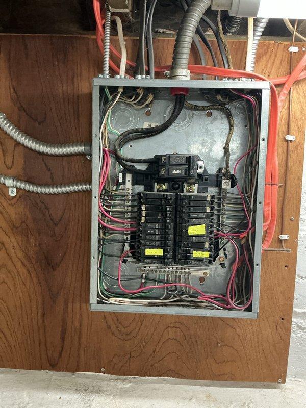 Installed new AC circuit and subpanel to support additional electrical load requirements. Ran exterior service conduit along building exterior with proper weatherhead installation, then established new subpanel in basement utility area with appropriate feeder conductors. Panel installation includes properly torqued main breaker, organized branch circuit breakers, color-coded phase conductors, and compliant grounding and bonding connections to meet current electrical code standards.