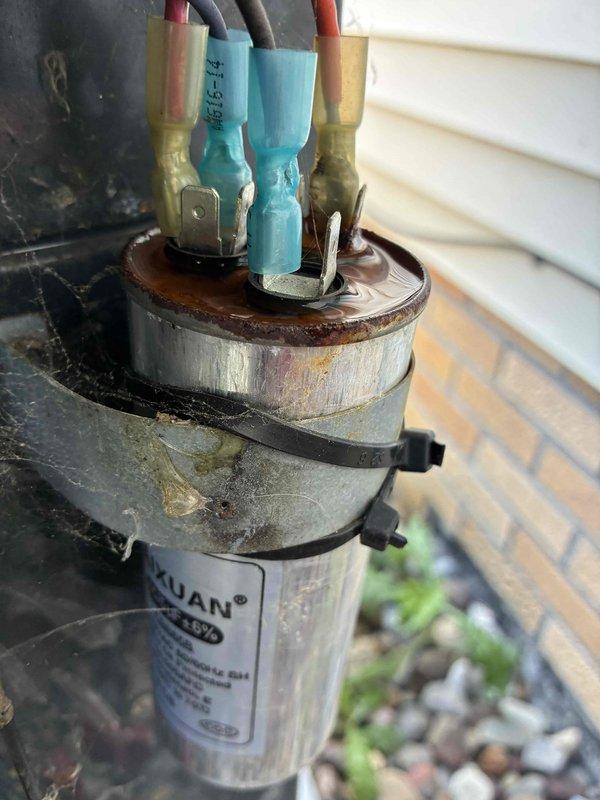 Completed preventive maintenance cooling visit on 10-year-old air conditioning system. Inspected outdoor condensing unit and indoor evaporator coil assembly, documenting existing capacitor with visible weathering and corrosion on terminal connections, as well as significant oxidation and rust buildup on evaporator coil copper tubing. Unit operational at time of inspection with all electrical connections secure and system functioning within normal parameters for equipment age.