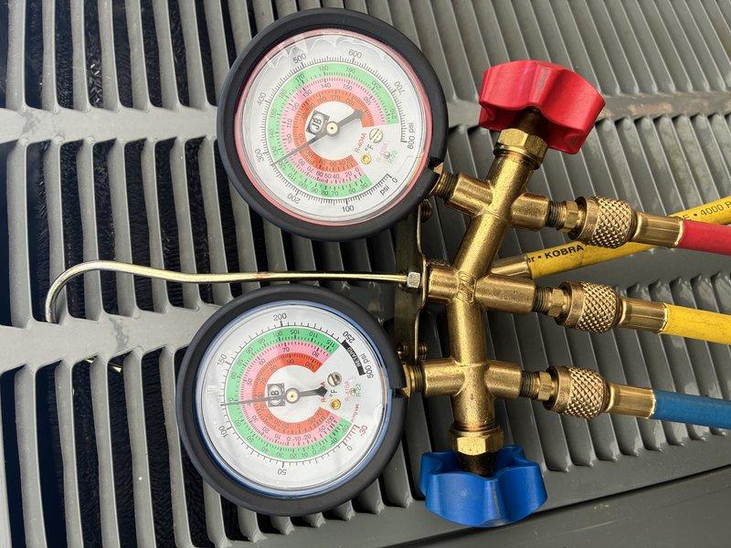 Performed routine cooling maintenance on an 18-year-old heat pump system. Conducted refrigerant pressure diagnostics using manifold gauges to verify system charge and operating pressures. Inspected and replaced a 35-amp, 250-volt fuse due to visible corrosion and discoloration at the contact points in the fuse holder, ensuring proper electrical protection for the unit.