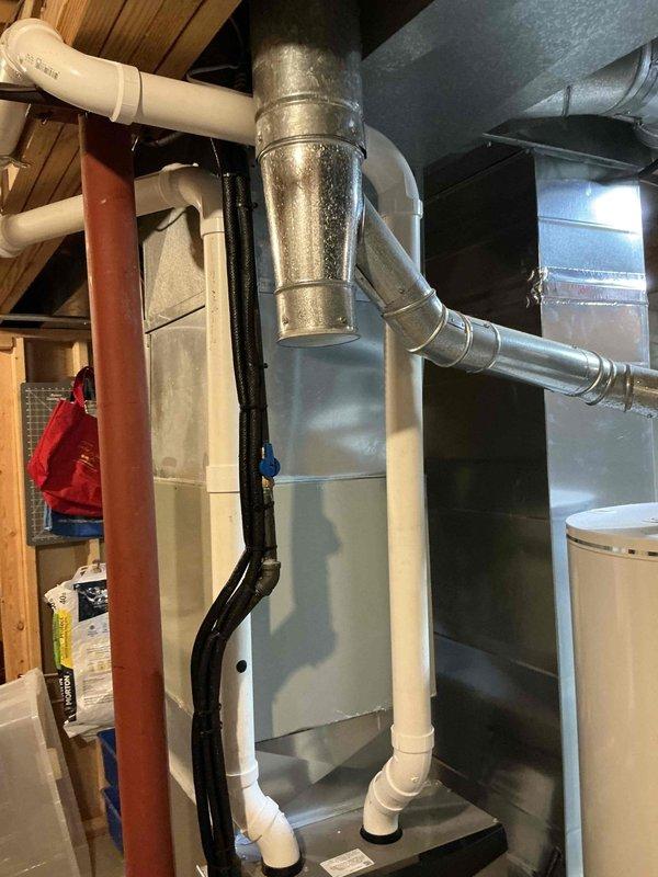 Completed comprehensive HVAC system replacement estimate for residential property. Evaluated existing outdoor condensing unit positioned on concrete pad with proper clearances and landscaping, as well as indoor air handler/furnace system with associated ductwork and drainage components in basement utility area. Assessment included review of current equipment condition, ductwork configuration, electrical connections, and condensate drainage system to provide replacement recommendations.