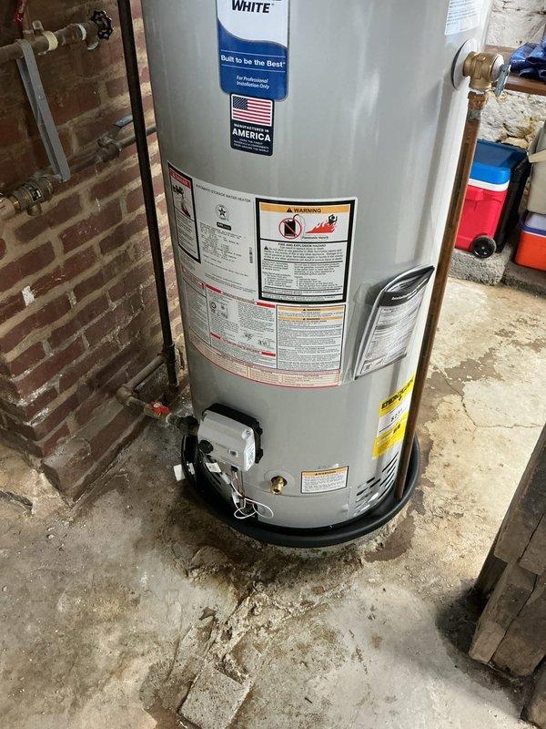Replaced existing water heater with new 40-gallon short tank unit featuring a 10-year tank warranty. Installed new expansion tank on cold water supply line at the water heater and properly capped off the previous expansion tank that was connected behind the unit with the supply line. Per customer request, installed a drain pan beneath the new water heater for added protection. All copper supply lines, brass fittings, shut-off valves, and flue venting were properly connected and tested for safe operation.