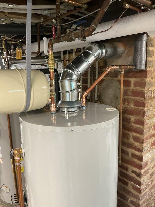 Replaced existing water heater with new 40-gallon short tank unit featuring a 10-year tank warranty. Installed new expansion tank on cold water supply line at the water heater and properly capped off the previous expansion tank that was connected behind the unit with the supply line. Per customer request, installed a drain pan beneath the new water heater for added protection. All copper supply lines, brass fittings, shut-off valves, and flue venting were properly connected and tested for safe operation.